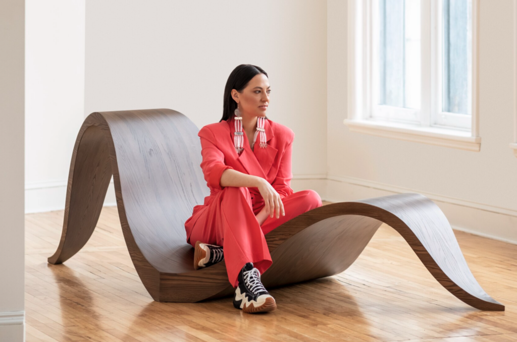 Caroline Monnet, who hails from Quebec, is shown seated on her premier chair design. Stories from her Indigenous Anishinaabe heritage provided inspiration for the sculptural form. | Photo ANDRÉ RIDER